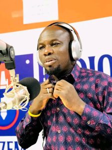 Haruna Kpei Zuu, Radio Tamale presenter, smiling warmly during a community event in Tamale.