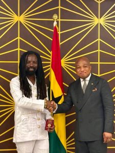 Rocky Dawuni receiving diplomatic passport from Minister Okudzeto Ablakwa